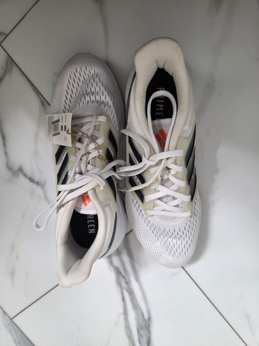 adidas Women’s White Athletic Shoes with Black Stripes and Orange Logo